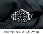 Small photo of The Rolex vintage wristwatch ceramic bezel model black oyster perpetual submariner date 39 mm display on black table with black cloth in the luxury watch shop