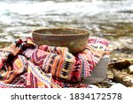 Small photo of Tibetan singing bowl and scarf. Translation of mantras. transform your impure body, speech and mind