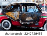 Small photo of Belgrade, Serbia - December 23, 2022: Car set on fire by an arsonist in the center of Belgrade. Burned down olditimer showpiece car in the famous street called Skadarlija in Belgrade city, Serbia