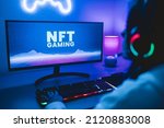 Young gamer buying NFT with token on marketplace platform for metaverse video game - Crypto technology trends - Focus on computer monitor