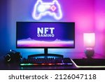 Metaverse and Blockchain Technology Concept - Gaming room displaying NFT marketplace on computer screen - Focus on monitor
