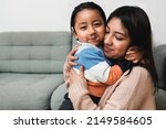 Happy Latin American mother and son hugging each other at home - Family love concept - Focus on child face