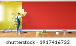 Man Painting Red Wall In Yellow ...