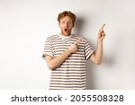 Excited man with curly red hair ...