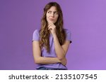 Small photo of Girl trying solve problem thinking solution make hmm face smirk frowning thoughtful look away touch chin pondering making choice deciding how act what do stand purple background focused
