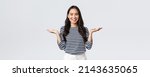 Small photo of Lifestyle, people emotions and casual concept. Cute smiling asian woman introduce two products, hold hands sideways as if demonstrating products on palms, standing white background