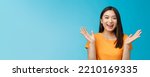 Small photo of Close-up friendly happy cute asian female student clap hands joyfully, smiling broadly looking funny amusing performance, stand enthusiastic blue background applause surprised