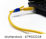 Small photo of broken network cable from laptop connected anyhow with insulating tape on white background