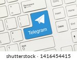 Close-up view on white conceptual keyboard - Telegram (blue key with logotype)