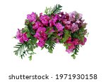 Tropical leaves and flower garland bouquet arrangement mixes orchids flower with tropical foliage fern, philodendron and ruscus leaves isolated on white background with clipping path.