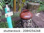 Small photo of An earthbound brown water barrel. yogyakarta, indonesia, december 1, 2021