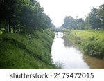 Small photo of the selokan river in yogyakarta, indonesia or saluran irigasi selokan mataram untuk pertanian sawah dan kolam ikan, peninggalan dari Raja Jogja