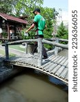 Small photo of A aqueduct building in the city of yogyakarta. Indonesia, December 10, 2022, saluran air melintas di taman area restoran kebun, terlihat tenang, relaks, alami dan betah, pengunjung makan dan minum