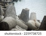 Small photo of A breakaway, from concrete mold on the beach, pemecah gelombang laut, pemecah ombak laut, di pantai, dari bahan beton bentuk segitiga diagonal, cetakan beton, pantai glagah, mengurangi hantaman ombak