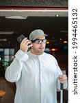 Small photo of Taken at Dubai, United Arab Emirates on 29th of May 2021: Blind Arab man uses the RightHear app to help him locate his destination. RightHear is an app for the blind and visually impaired.