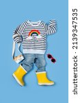 Small photo of Childrens jumper with jeans and yellow gumboots. Cute Set of kids clothes and accessories. Fashion Baby outfit for spring, autumn or summer.