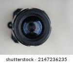 Small photo of Surveillance camera on a gray background. Closeup. The concept of covert surveillance