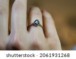 Small photo of Solitaire diamond ring, water drop shaped solitaire diamond ring on finger, top view close up macro photo
