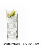 Small photo of Shot of a glass of gin and tonic with ice and lime on white background with copy space