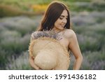 Woman without bra standing in a lavender field