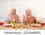 Asian Muslim family having dinner, Arabian family eating iftar in Ramadan.Break fasting during Ramadan.