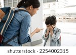 Small photo of Asian Mother scolds her son while travel . A child cries, a woman shakes her finger because of the boy bad behavior Rule of conduct. boy cover his face and cry.