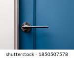 Blue colored door with handle in modern design apartment close-up