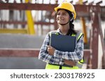 Small photo of India engineer woman working with document at precast site work
