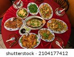 Small photo of Flatlay of a full table spread containing traditional dishes for Chinese Lunar New Year. Each dish has a symbolic meaning for the celebration.