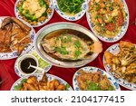 Small photo of Flatlay of a full table spread containing traditional dishes for Chinese Lunar New Year. Each dish has a symbolic meaning for the celebration.