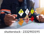 Small photo of The warehouse safety officer inspects the check list of hazardous chemicals dangerous to meet safety standards before transport or distributed to industrial plants or export to foreign countries.