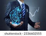 Small photo of Businessman or stock exchange market speculator holding a digital polygonal bull in hand depicting profitability in a bull market and carefully studying investment information candle chart background