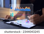 Small photo of Businessman reading data in bar graph and pie chart form on virtual data analytic dashboard in office. Business analysis for investment and online digital marketing