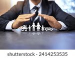 Small photo of insurance concept with businessman using two hand in protection gesture to family life and property like a car and house represent to ensure and worry free in any activity