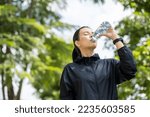 Happy slim woman drinking water ...