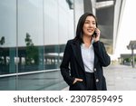 Portrait beautiful Businesswoman in suit with smartphone standing at the buildings downtown. Confident woman using cellphone. Executive Smart businessman