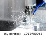 stock-photo-high-precision-cnc-machining-center-working-operator-machining-automotive-sample-part-process-in-1016900068.jpg