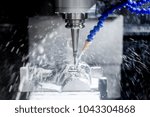 stock-photo-high-precision-cnc-machining-center-working-operator-machining-automotive-sample-part-process-in-1043304868.jpg