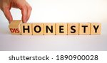 Small photo of Honesty or dishonesty symbol. Businessman hand turns cubes and changes the word 'dishonesty' to 'honesty'. Beautiful white background. Business and honesty or dishonesty concept. Copy space.
