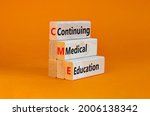 Small photo of CME, continuing medical education symbol. Wooden blocks with words CME, continuing medical education on beautiful orange background. Business, CME, continuing medical education concept.