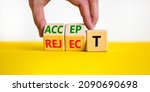 Small photo of Accept or reject symbol. Businessman turns wooden cubes and changes the word reject to accept. Beautiful yellow table, white background, copy space. Business and accept or reject concept.