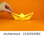 Small photo of Welcome onboard and support symbol. Concept words Welcome onboard on yellow paper boat on a beautiful orange table orange background copy space. Businessman hand. Business and Welcome onboard concept.