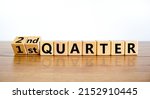 Small photo of From 1st first to 2nd second quarter symbol. Turned wooden cubes and changed words 1st quarter to 2nd quarter. Beautiful wooden table white background. Business happy 2nd quarter concept. Copy space.
