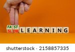 Fast or slow learning symbol. Businessman turns cubes, changes words 