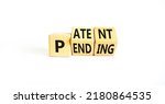 Small photo of Patent pending symbol. Concept words Patent pending on wooden cubes. Beautiful white table white background. Business and patent pending concept. Copy space.