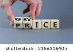Small photo of Service price symbol. Hand turns a cube and changes the words 'service' to 'price'. Beautiful grey background. Business and service price concept. Copy space.