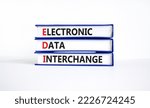 Small photo of EDI electronic data interchange symbol. Concept words EDI electronic data interchange on books on a beautiful white background. Business and EDI electronic data interchange concept. Copy space