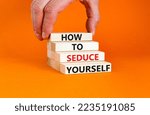 Small photo of How to seduce yourself symbol. Concept word How to seduce yourself on wooden blocks. Businessman hand. Beautiful orange table orange background. Business and how to seduce yourself concept. Copy space