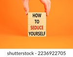 Small photo of How to seduce yourself symbol. Concept word How to seduce yourself on wooden blocks. Businessman hand. Beautiful orange table orange background. Business and how to seduce yourself concept. Copy space