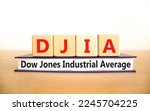 Small photo of DJIA Dow Jones industrial average symbol. Concept words DJIA Dow Jones industrial average on wooden block on beautiful white background. Business DJIA Dow Jones industrial average concept. Copy space